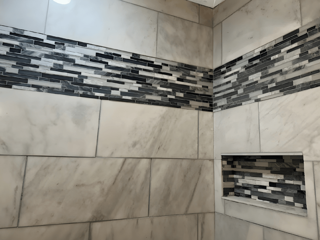 Modern bathroom shower remodel with tile accent wall installed by All American Home Remodel in Denver Colorado
