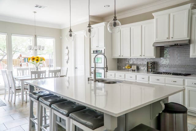 modern kitchen remodeling with white cabinets and island by a home remodeling contractor in Denver Colorado